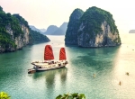 Sail through limestone cliffs in Halong Bay