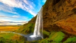 Walk behind the cascading water of Seljalandsfoss waterfall